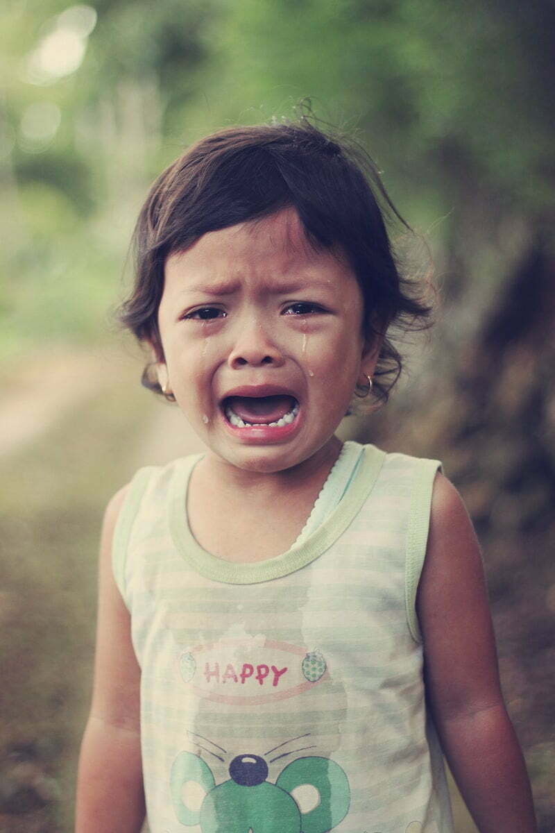 selective focus photography of girl crying